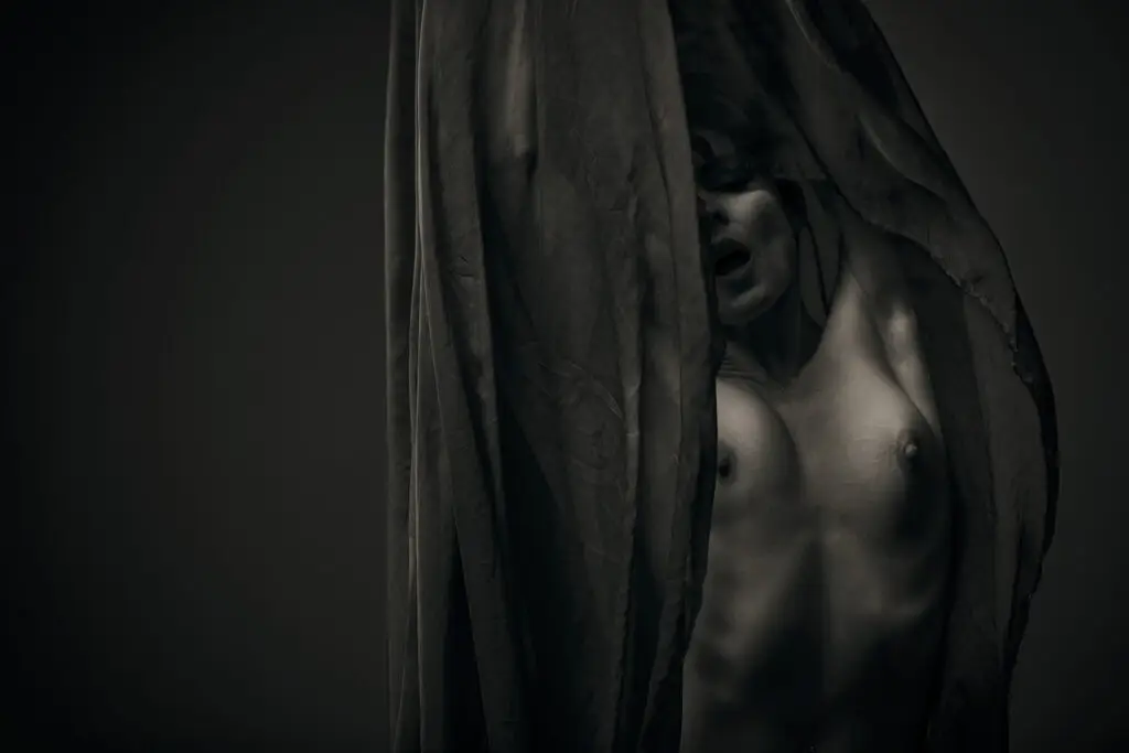 Kristy jessica art nude model with mouth open in black and white color slender body textured fabric
