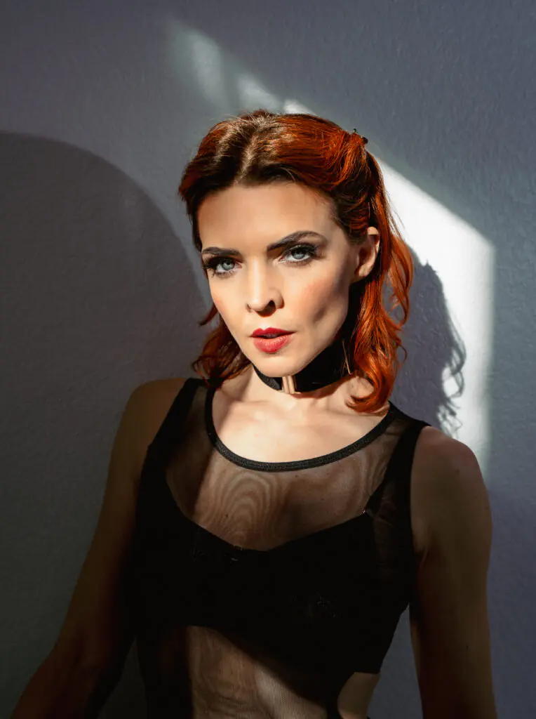 sunny goth girl portrait blue eyes red hair black collar